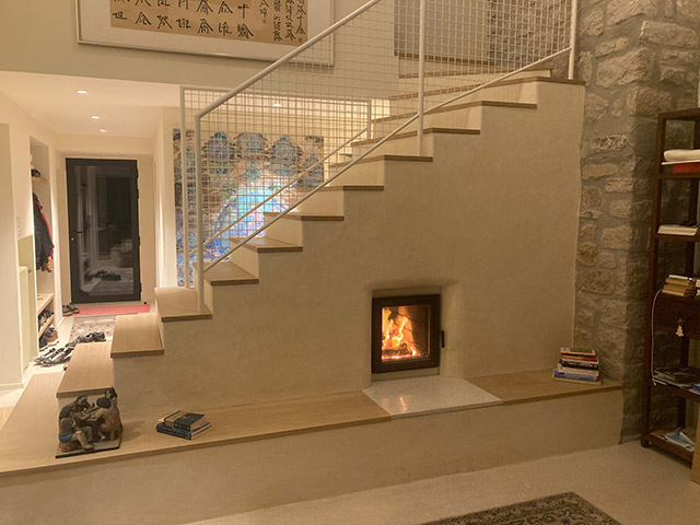 Poêle de masse double face sous escalier en Bretagne